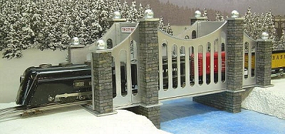 This is Howard's Marx Cornelius Vanderbilt locomotive bringing an O gauge tinplate train across the bridge. Click for bigger photo.